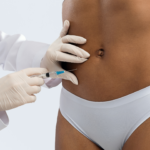 doctor giving a woman an injection in her abdomen