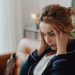 Woman holding her head headache