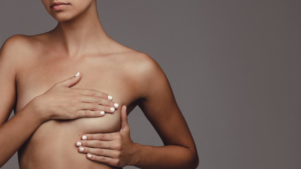 woman covering breast with hand