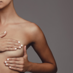 woman covering breast with hand