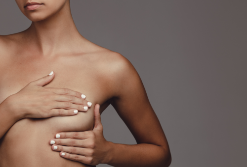 woman covering breast with hand