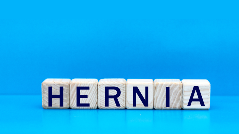 wooden blocks saying hernia on blue background
