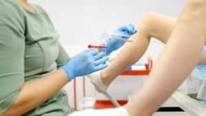 woman at doctor office for pap smear test examination doctor holding speculum