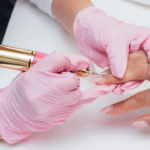 Woman's hands getting a russian manicure with a mechanical electrical drill file to trim cuticles