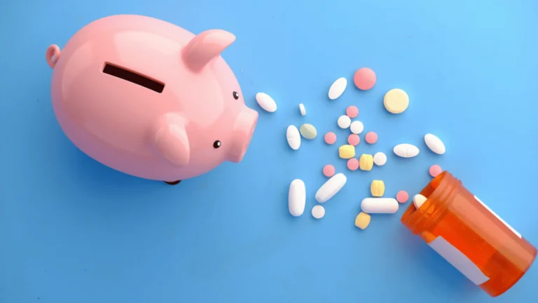 piggy bank and prescription medications on a blue background saving money on medications