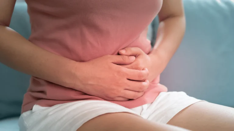 woman clutching abdomen in pain