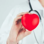 woman doctor holding up a heart for heart disease