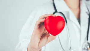 woman doctor holding up a heart for heart disease